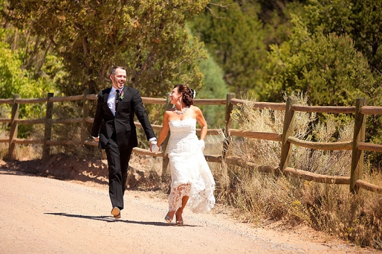 Happy newlywed couple strolls hand in hand outdoors
