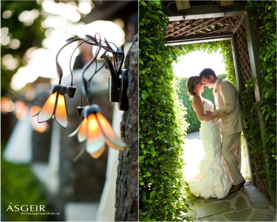 Newlyweds embrace in garden arbor floral wedding lights