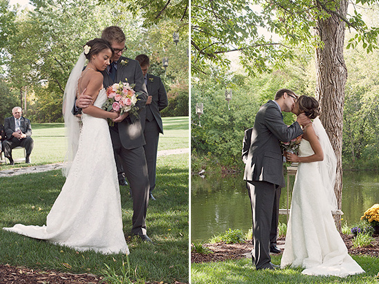 Couple kissing outdoors at wedding ceremony