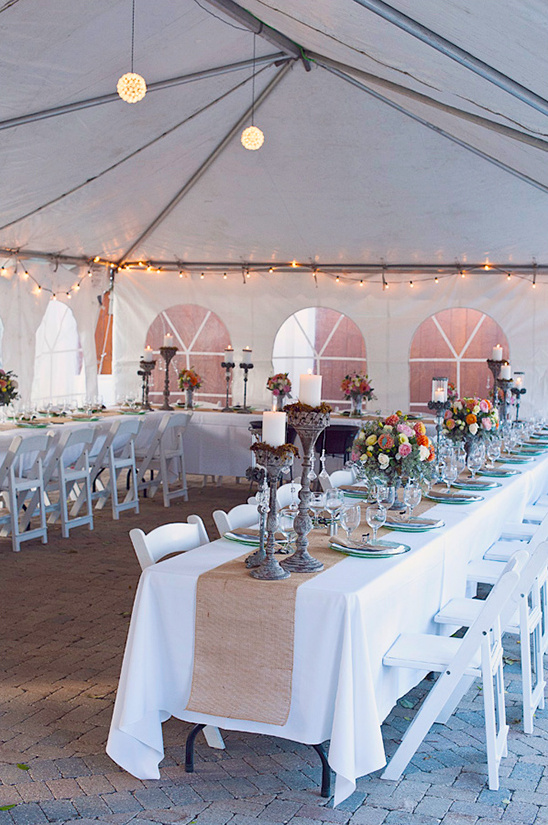 Wedding reception tent with tables and flowers