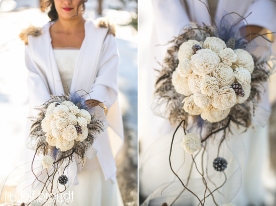 Elegant winter wedding bouquet with ivory sola flowers and feathers