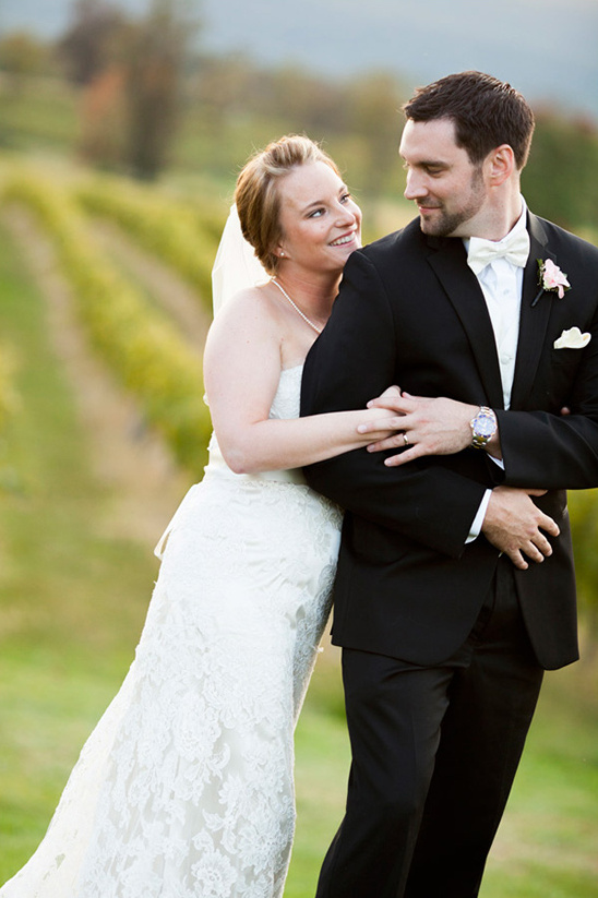 Bride adoring groom on their vineyard wedding day