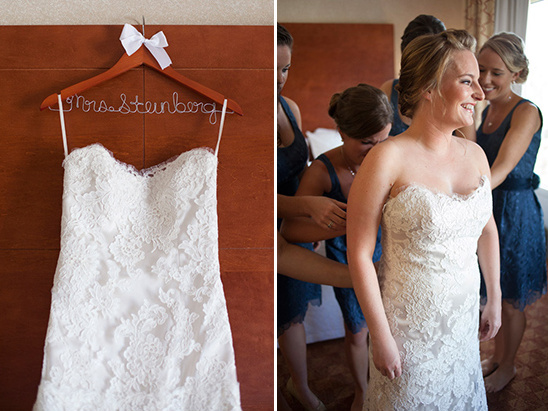 Bride being helped into her lace wedding gown
