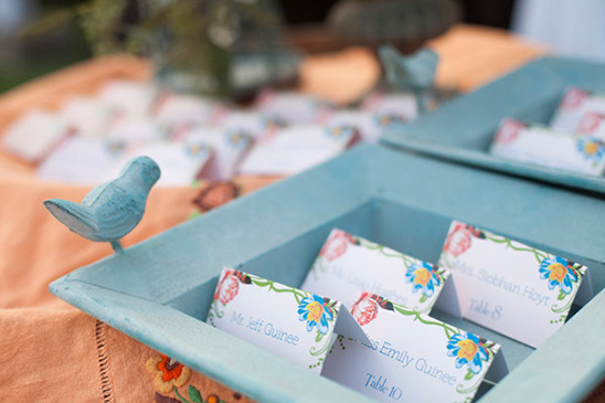 Wedding place cards in a blue bird adorned tray