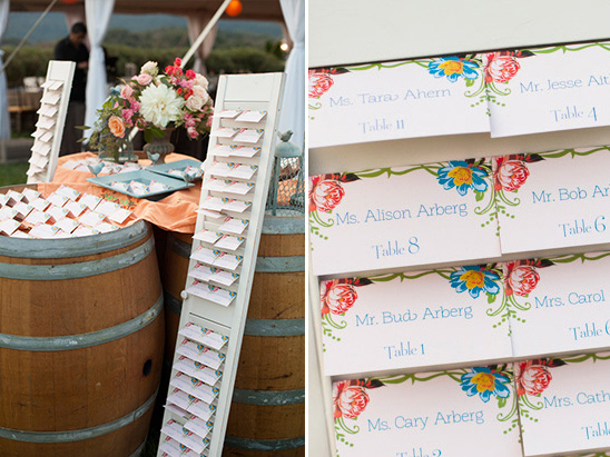 Wedding table assignments cards on barrels display