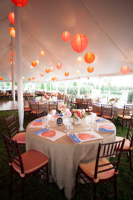 Outdoor wedding reception table with coral lanterns