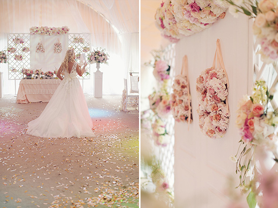 Bride in wedding dress with floral backdrop