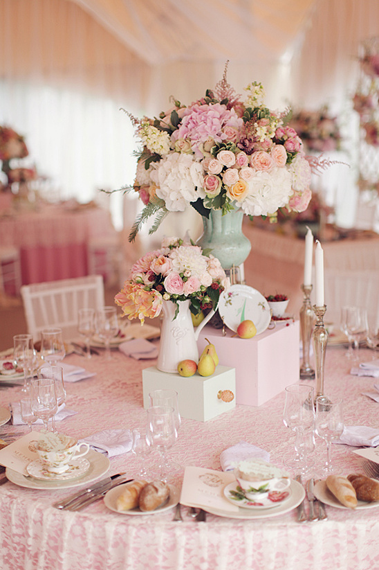 Pink floral centerpiece adorns wedding table
