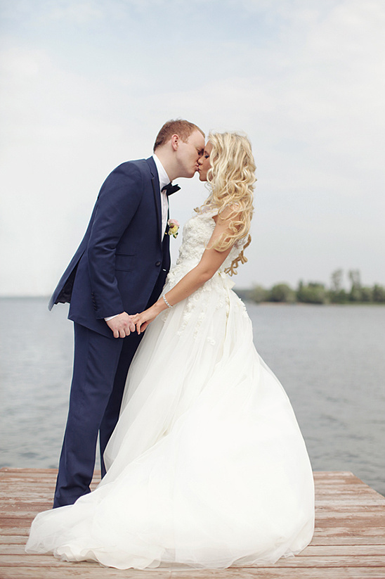 Loving couple kissing on wedding dock