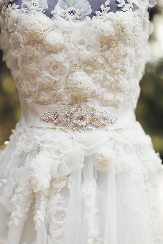 Ornate wedding dress with floral lace and jeweled belt