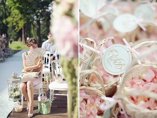 Wedding guests with fans, flower petals in baskets