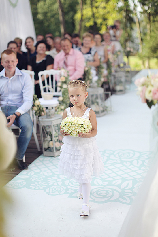 Flower girl carrying bouquet at wedding