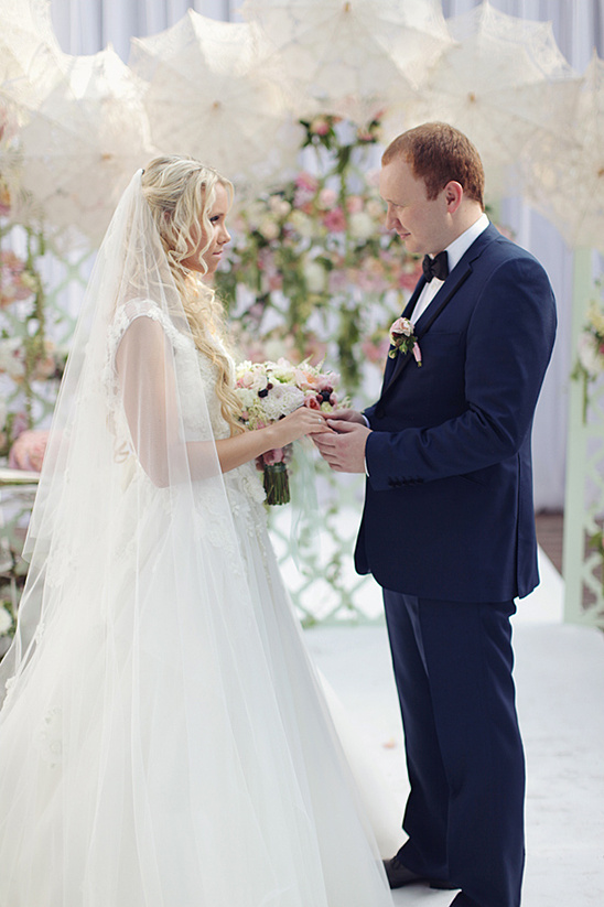 Bride and groom exchanging rings at wedding ceremony