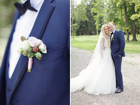 Happy couple in wedding attire, groom's boutonniere