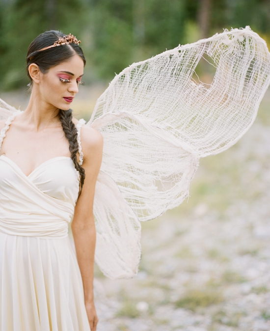Woman in fairy costume with textured wings outdoors