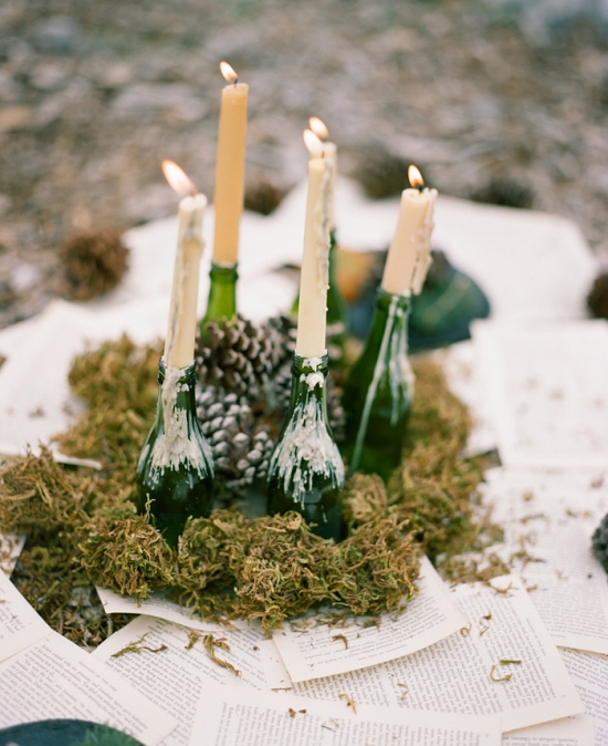Rustic candle arrangement on moss and pages outdoors