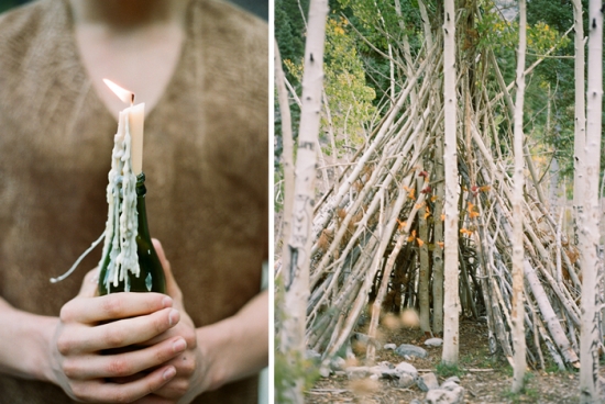 Burning candle in bottle with forest shelter behind