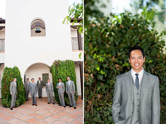 Groomsmen in grey suits posing with the smiling groom to be