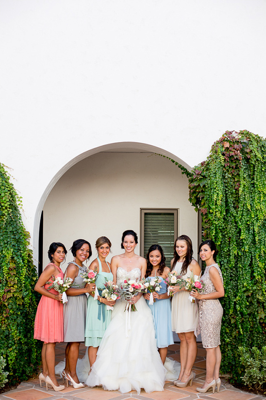 Bride and bridesmaids posing for a wedding photo outdoors