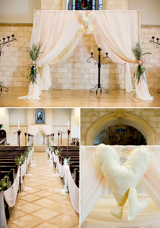 Elegant church wedding ceremony with flowing fabric and heart decor