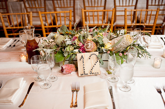 Elegant wedding table setting with floral centerpiece and number 12 sign