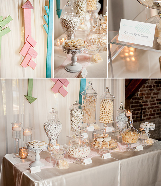 Elegant candy buffet with jars, treats, and decorative arrows