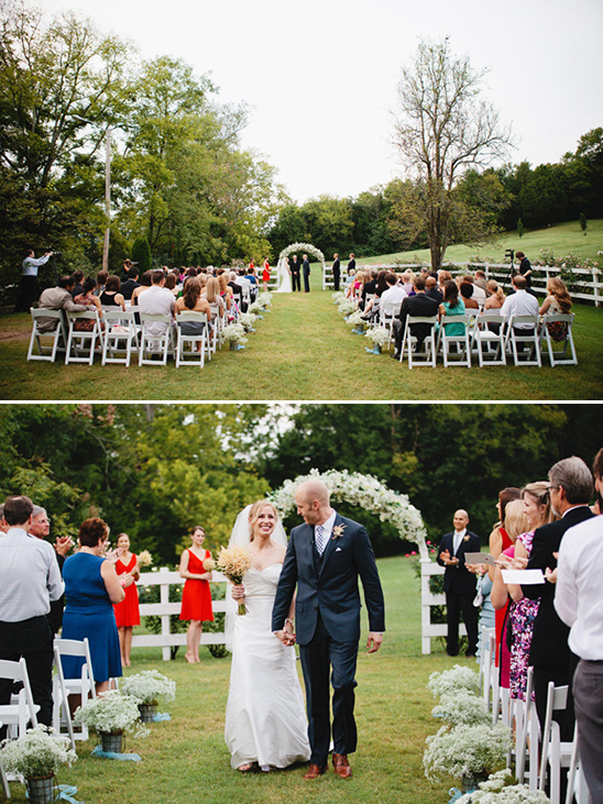 Couple walking away from outdoor wedding ceremony