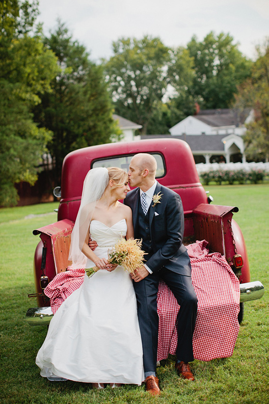 Couple kissing on vintage truck bed