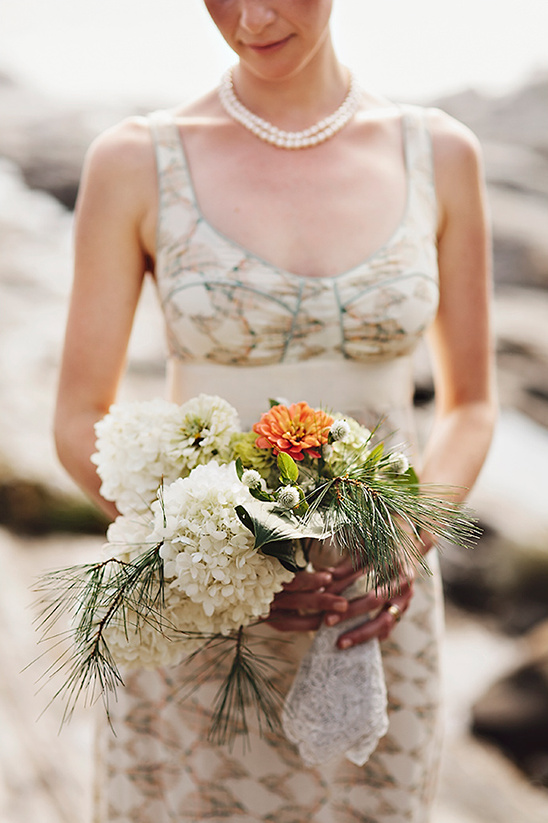 Bride holding a wedding bouquet of white flowers