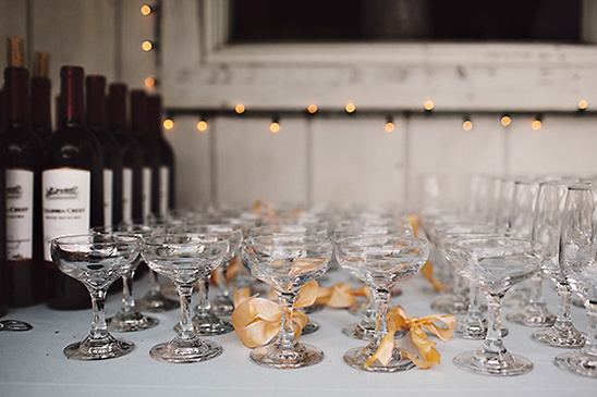 Wine bottles and champagne glasses with gold ribbons