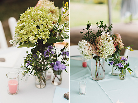 Rustic wedding centerpieces in mason jars with candles