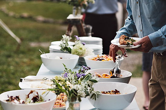 Buffet table with salads at an outdoor event