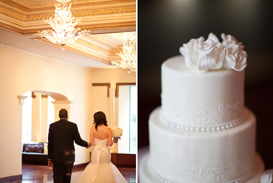 Elegant wedding couple walking towards a beautiful white cake