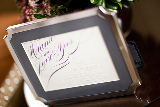 Elegant silver frame displays Melanie and Jean Yves wedding invitation