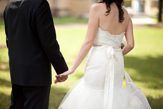Bride and groom holding hands, wedding day