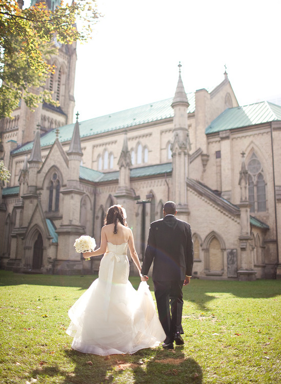 Bride and groom walking away after church wedding
