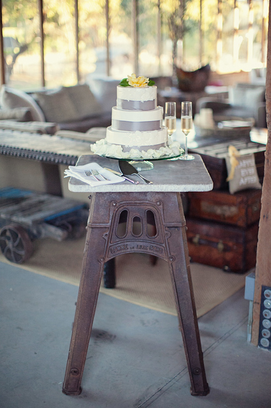 Elegant wedding cake on an industrial-style table with champagne