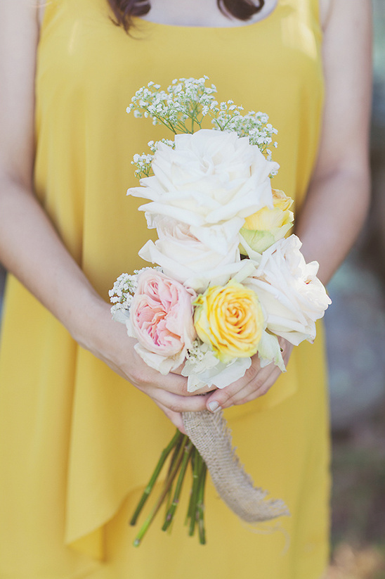 Woman holding a beautiful bouquet of colorful roses and flowers