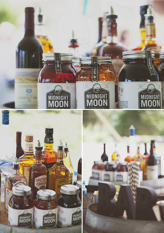 Cocktail bar with Midnight Moon moonshine bottles and other drinks