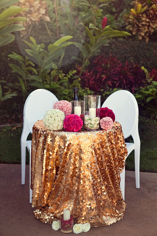 Romantic sweetheart table with gold sequins and florals