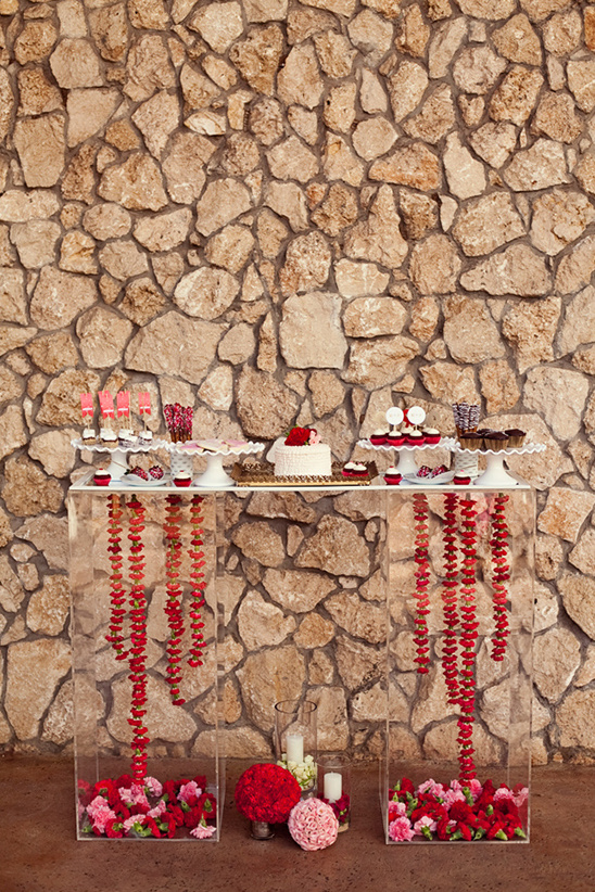 Dessert table with flowers and stone background
