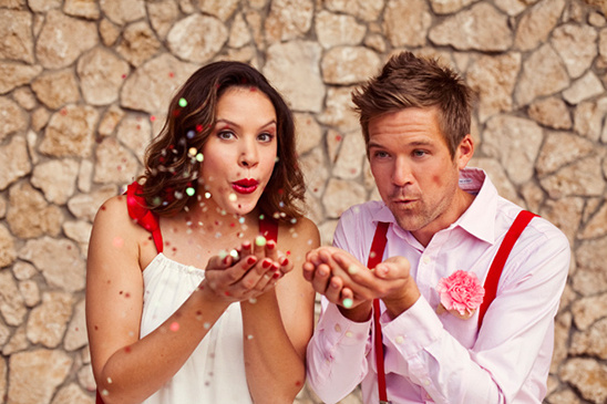 Couple joyfully blowing confetti, celebrating love