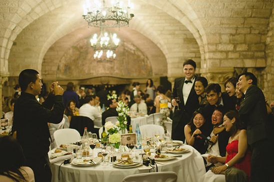 Wedding guests celebrate in a stone-walled venue