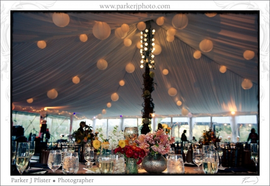 Romantic wedding reception tent decorated with paper lanterns and floral centerpieces