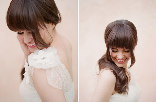 Smiling bride with bangs and floral shoulder detail
