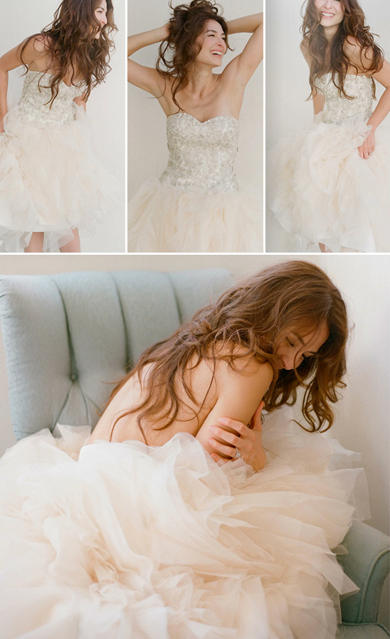Bride in tulle skirt and strapless beaded top poses playfully