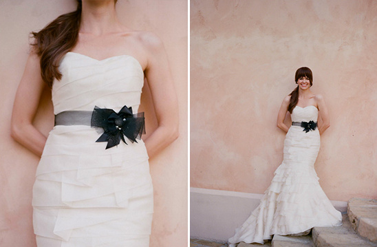 Elegant bride in white strapless gown with black sash bow