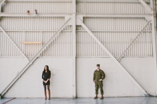 Couple posing in a hangar for a portrait photo shoot