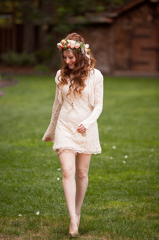 Woman in floral crown, lace dress, walking outdoors