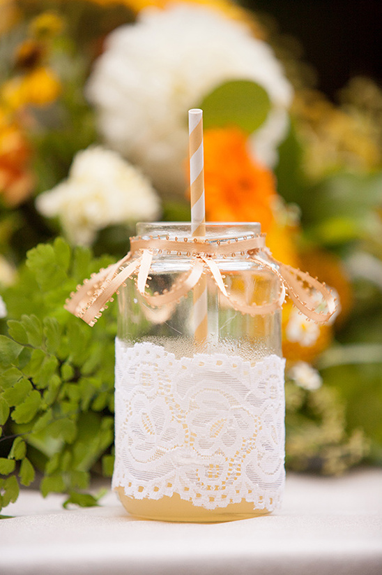 Mason jar with lace ribbon straw and flowers